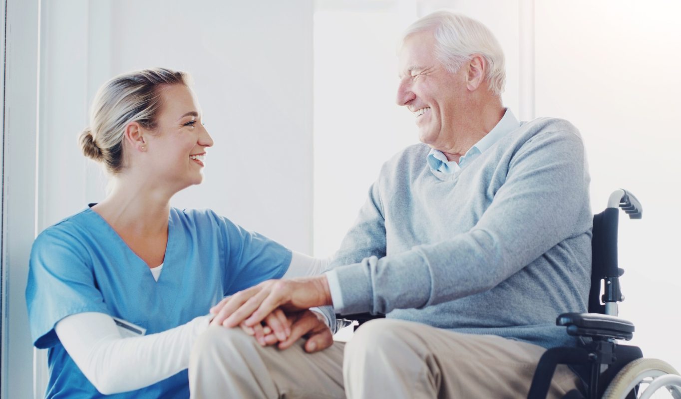 GettyImages-2174052664 A man and woman sitting on the couch holding hands.