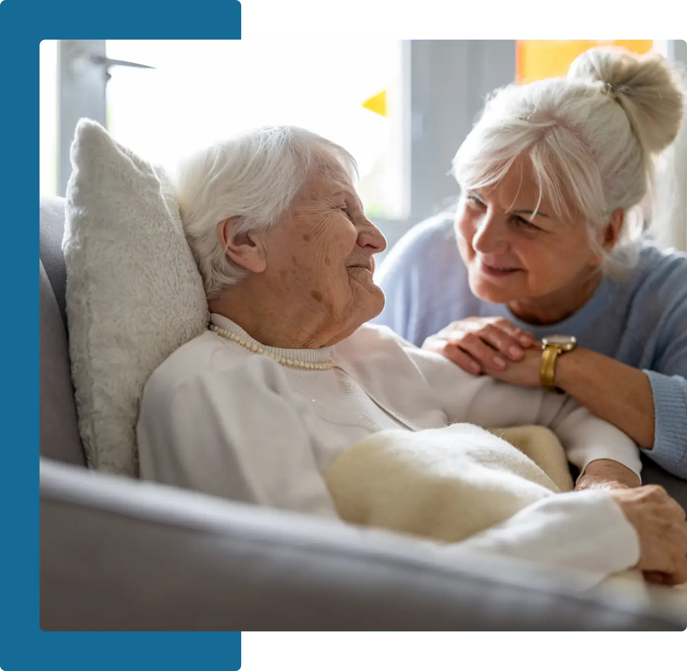 A woman is holding the arm of an older person.