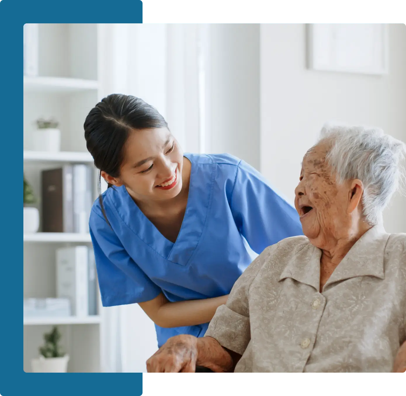 A nurse is helping an elderly woman in a wheelchair.